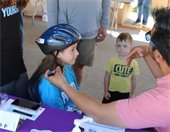 Children with bike helmets smiling