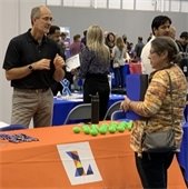 A woman at a Parks and Recreation booth at a job fair