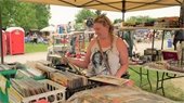 A woman shopping for vinyl at the Greenmead Flea Market
