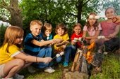Children roasting marshmallows over a fire