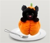 A stuffed cat popping its head out of a stuffed pumpkin