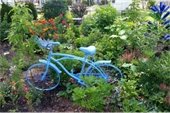 Garden with a blue bike as art