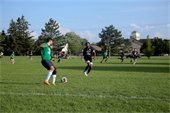 Men playing soccer in a field