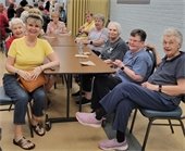 Smiling seniors at a table with napkins