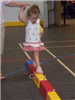 Adult Helping a Child Across a Balance Beam