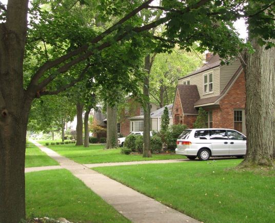 A Silver Sedan Parked in Front of a Home