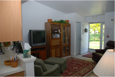 Living room area with  two recling chairs and a television